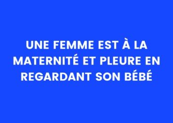 une femme est à la maternité et regarde son bébé en pleurant