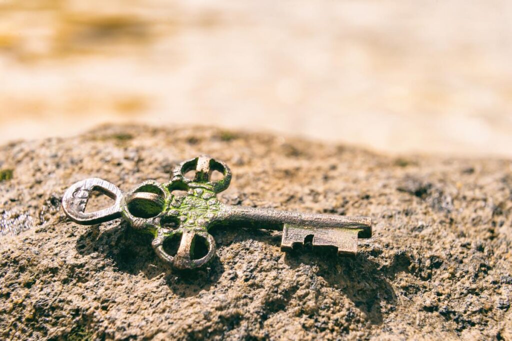 Treasure key lost on rock at the beach. Opportunity or Mystery concept. 