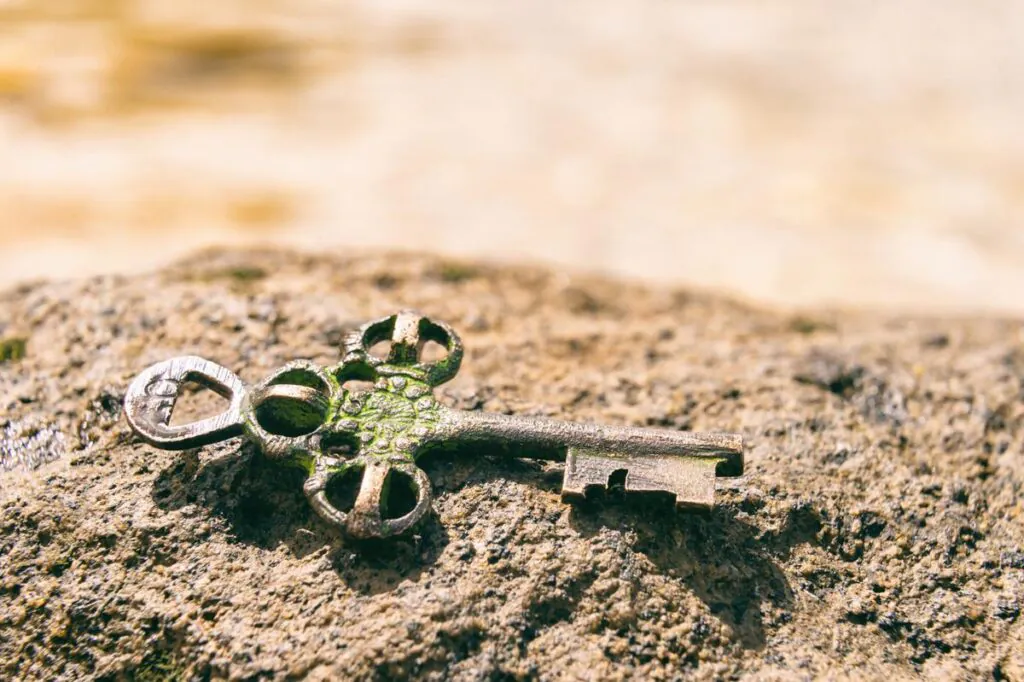 Treasure key lost on rock at the beach. Opportunity or Mystery concept.